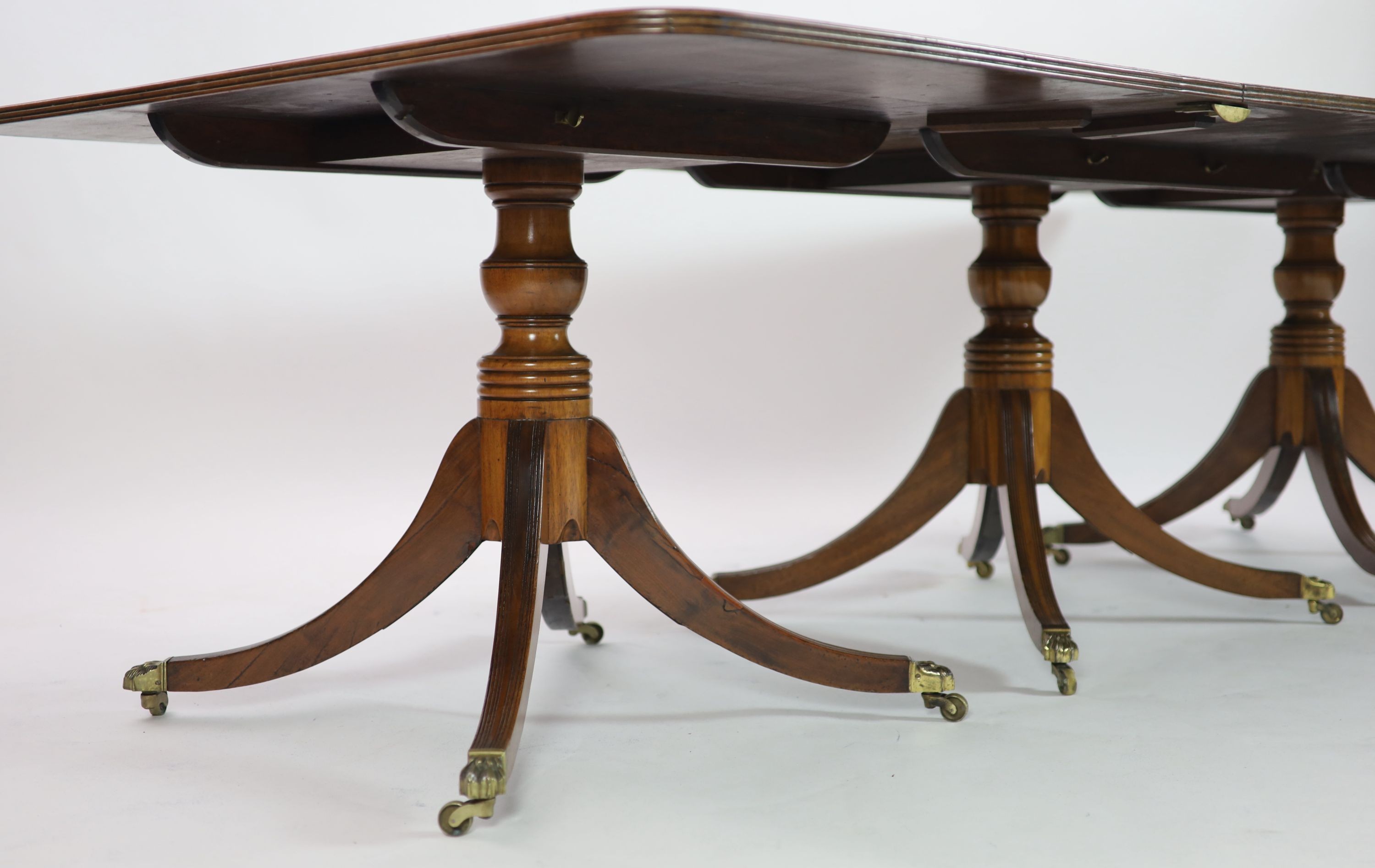 A Regency and later mahogany triple pedestal dining table, W.258cm D.132cm Extends to 362cm H.74cm